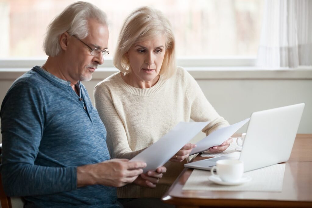 Middle-aged man and woman worried about finding the right virtual assistant. 