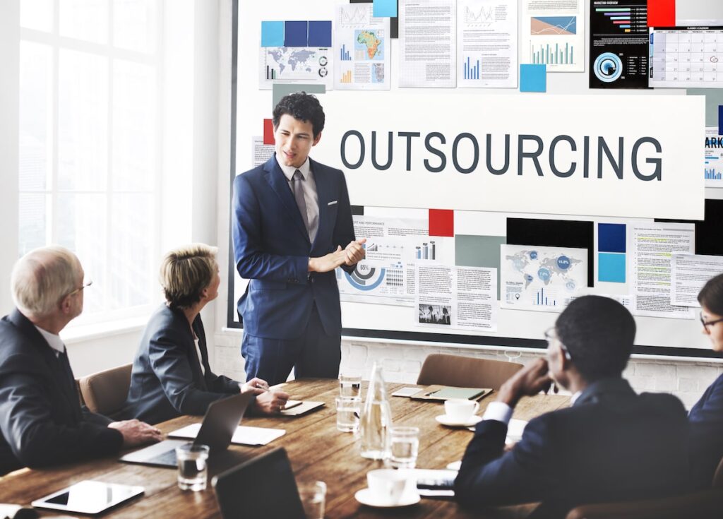 Members of an outsourcing agency discussing work.