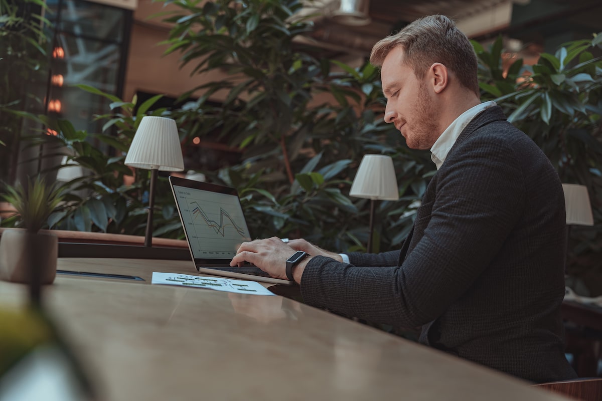 man working on accounting charts remotely