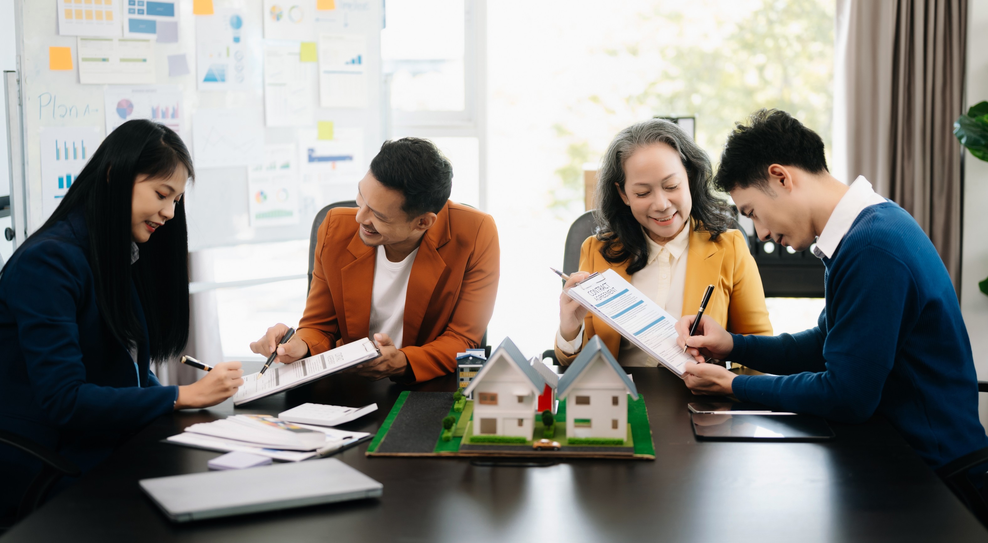 Real estate agents discussing house models
