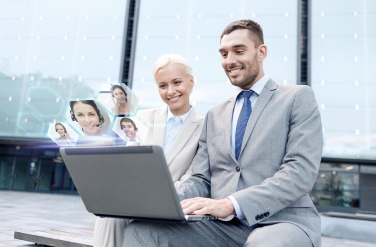Business professionals using laptop with digital profiles