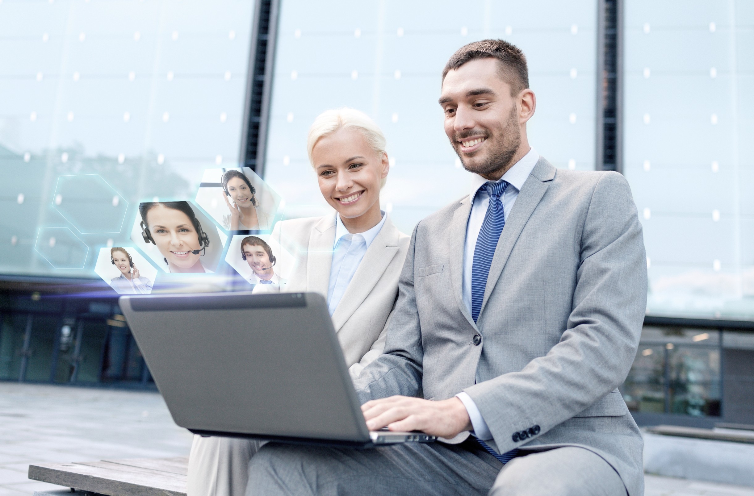 Business professionals using laptop with digital profiles