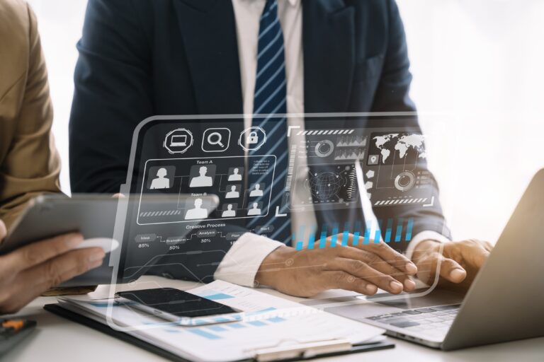 Businessman using laptop with digital data display