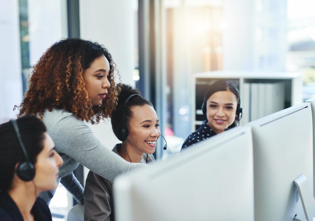 Customer service team collaborating at computers