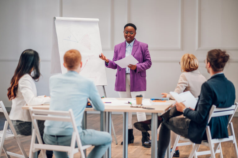 Businesswoman presenting financial data to team
