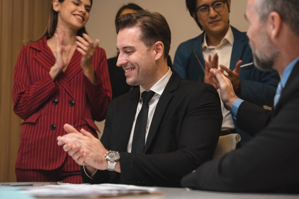 Businessman clapping with applauding colleagues