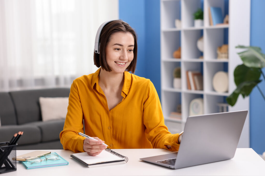 Woman studying on laptop with headphones