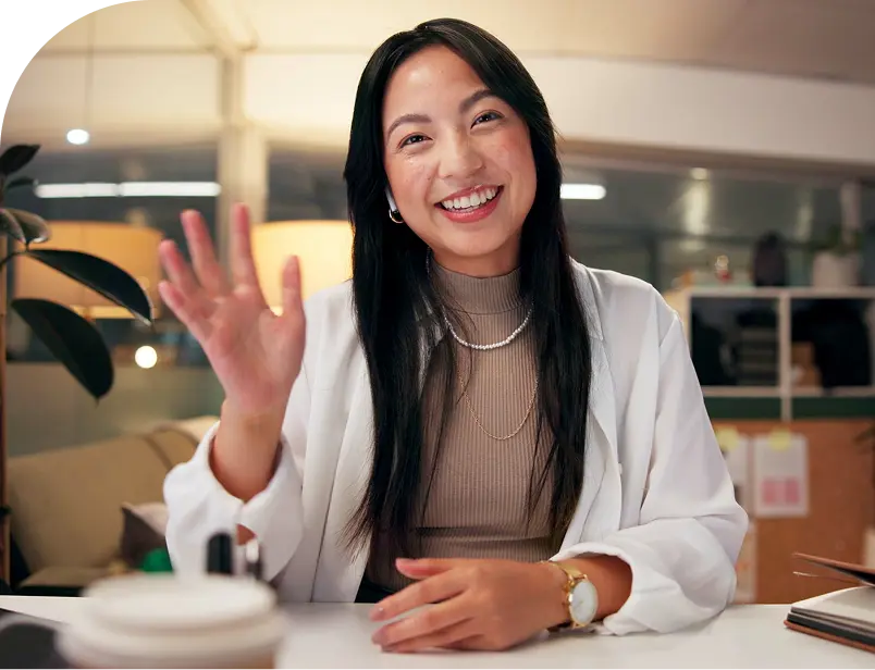 Woman waving on virtual staff video call