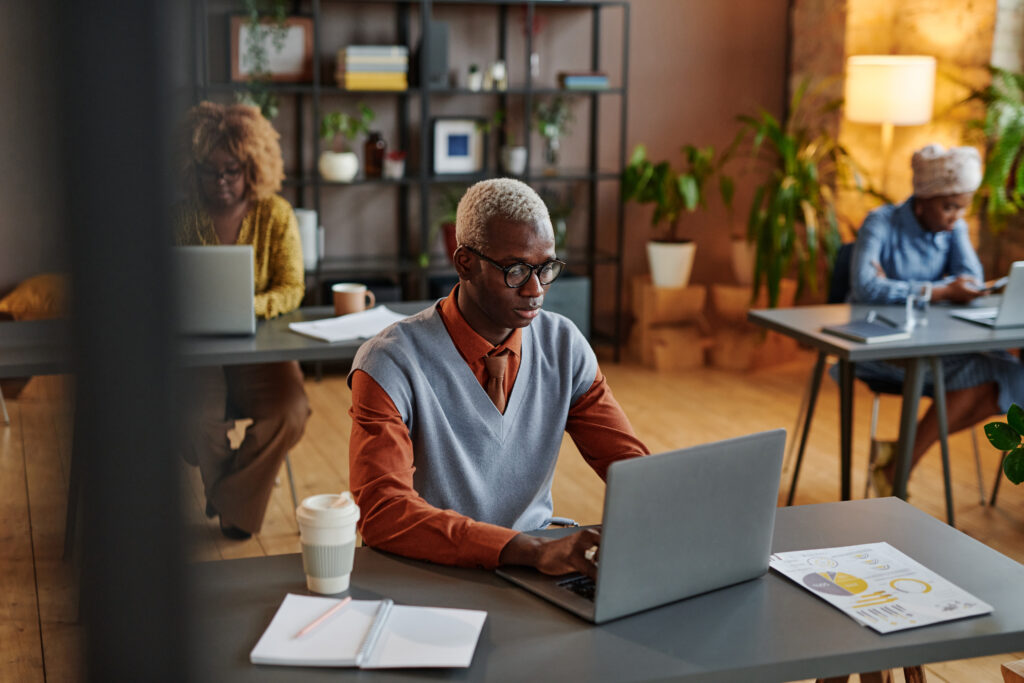 Man typing on laptop in office environment
