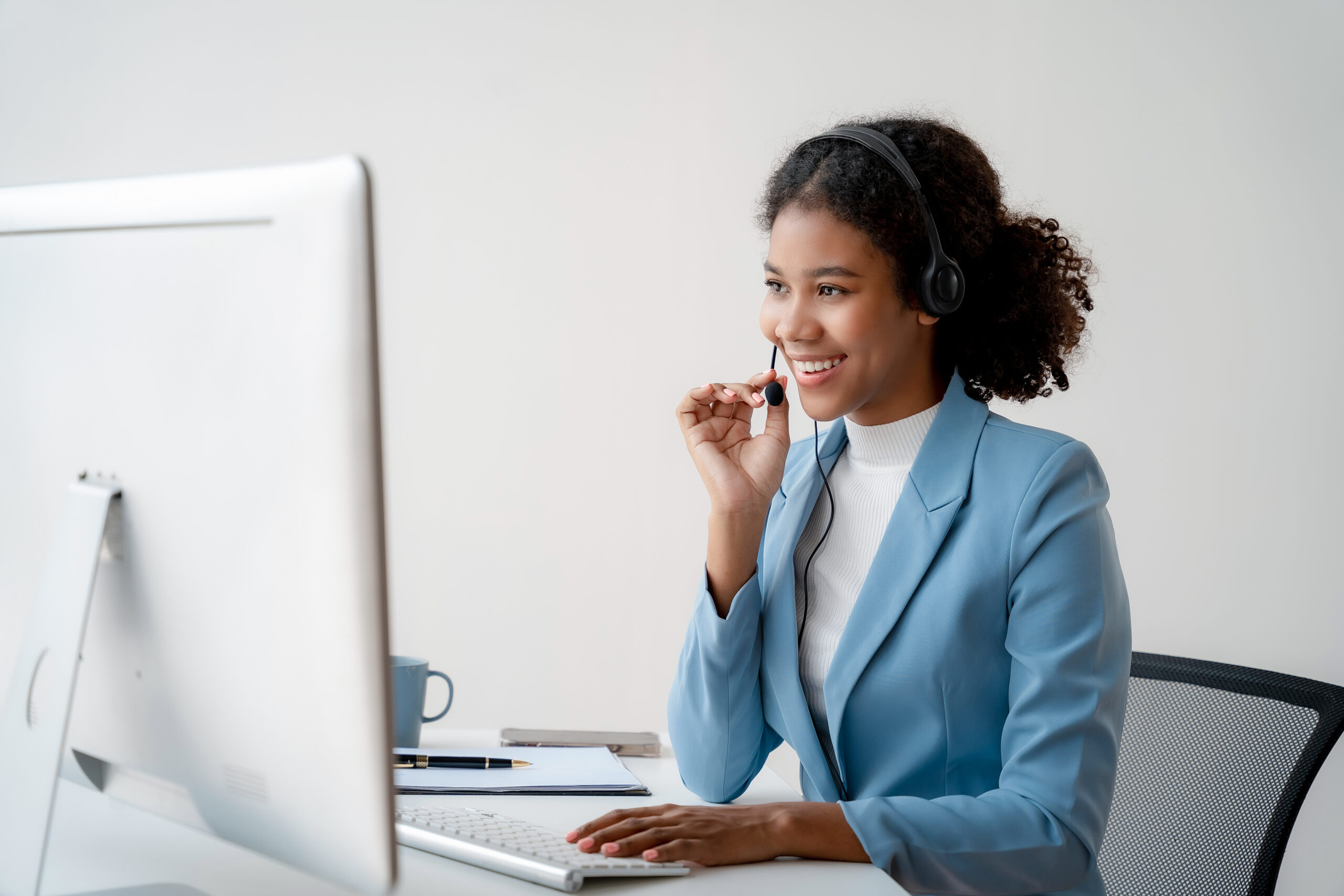Customer service agent with headset smiling
