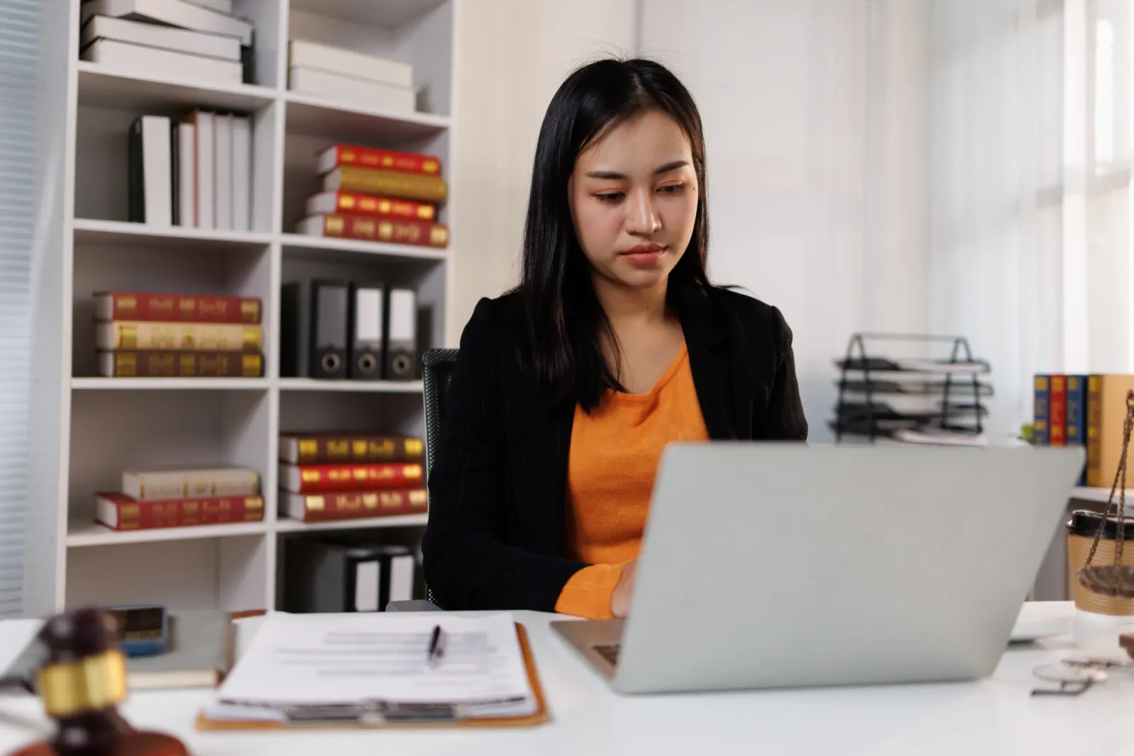 Female lawyer working on laptop in office